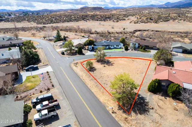 an aerial view of lake and residential houses with outdoor space