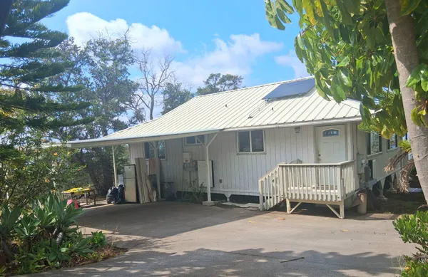 a view of a house with a balcony and yard