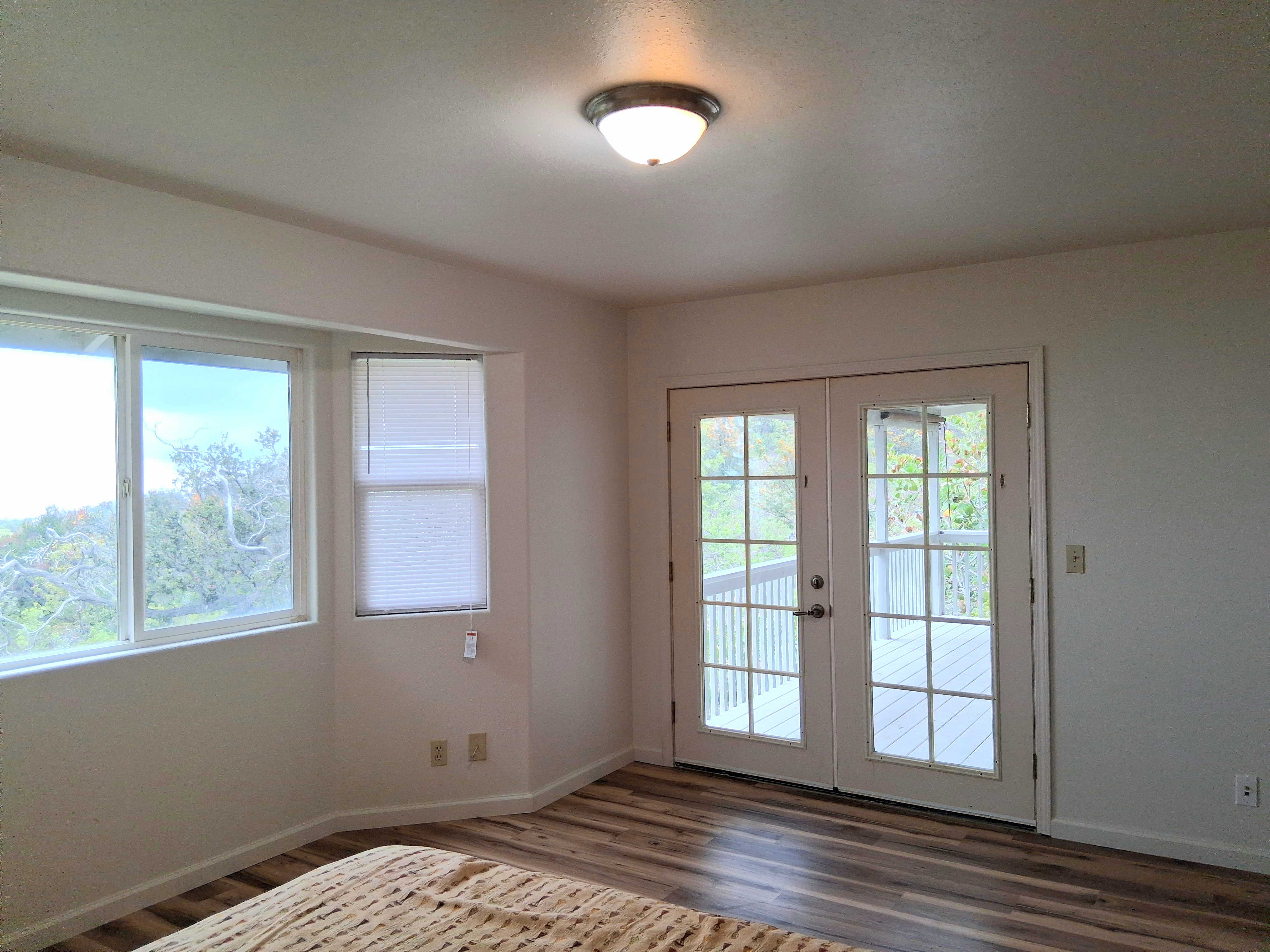 92-8221 Reef Parkway Ocean View, HI 96704 - Photo 12 of 20 a view of empty room with wooden floor and fan