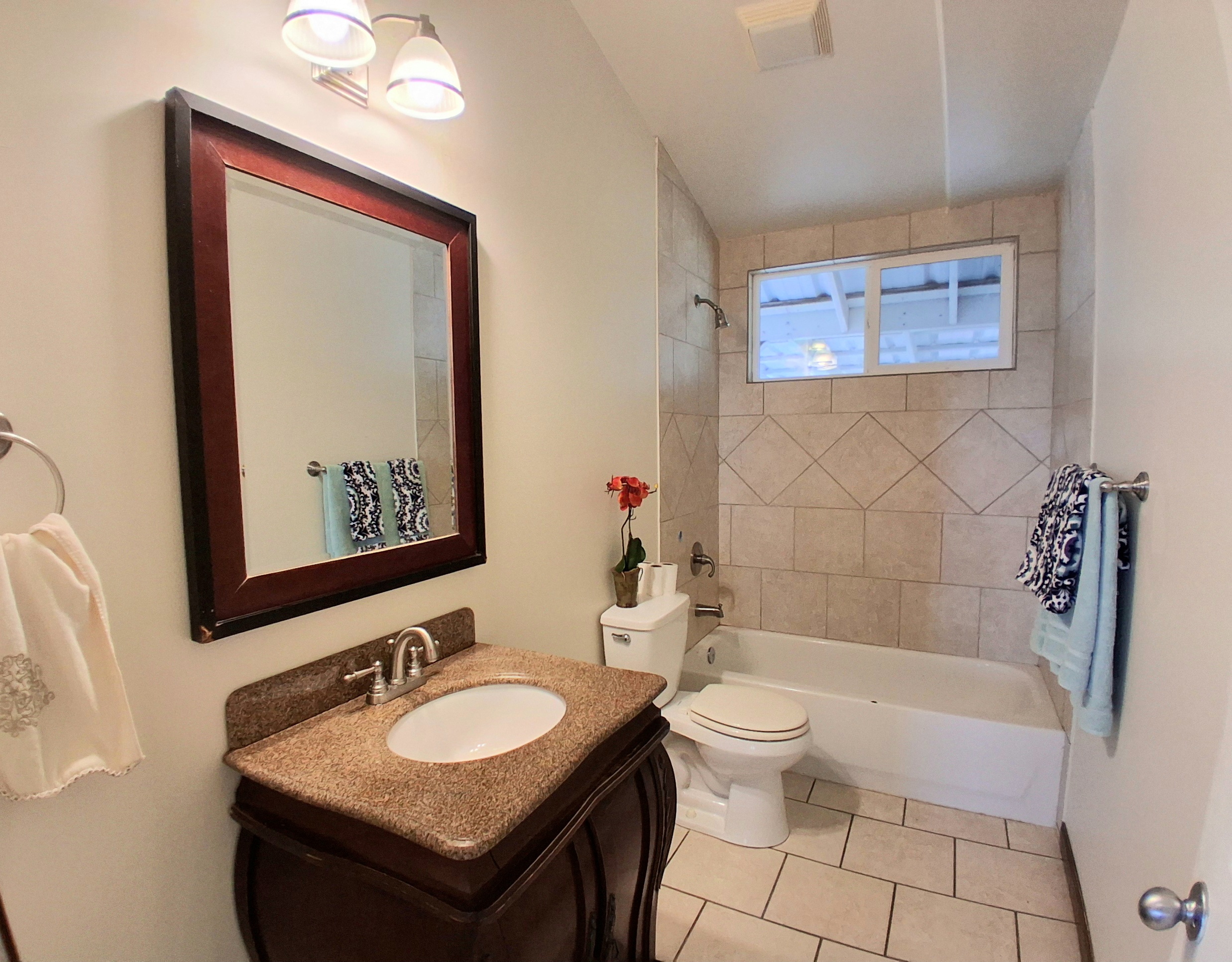 92-8221 Reef Parkway Ocean View, HI 96704 - Photo 16 of 20 a bathroom with a sink and a mirror