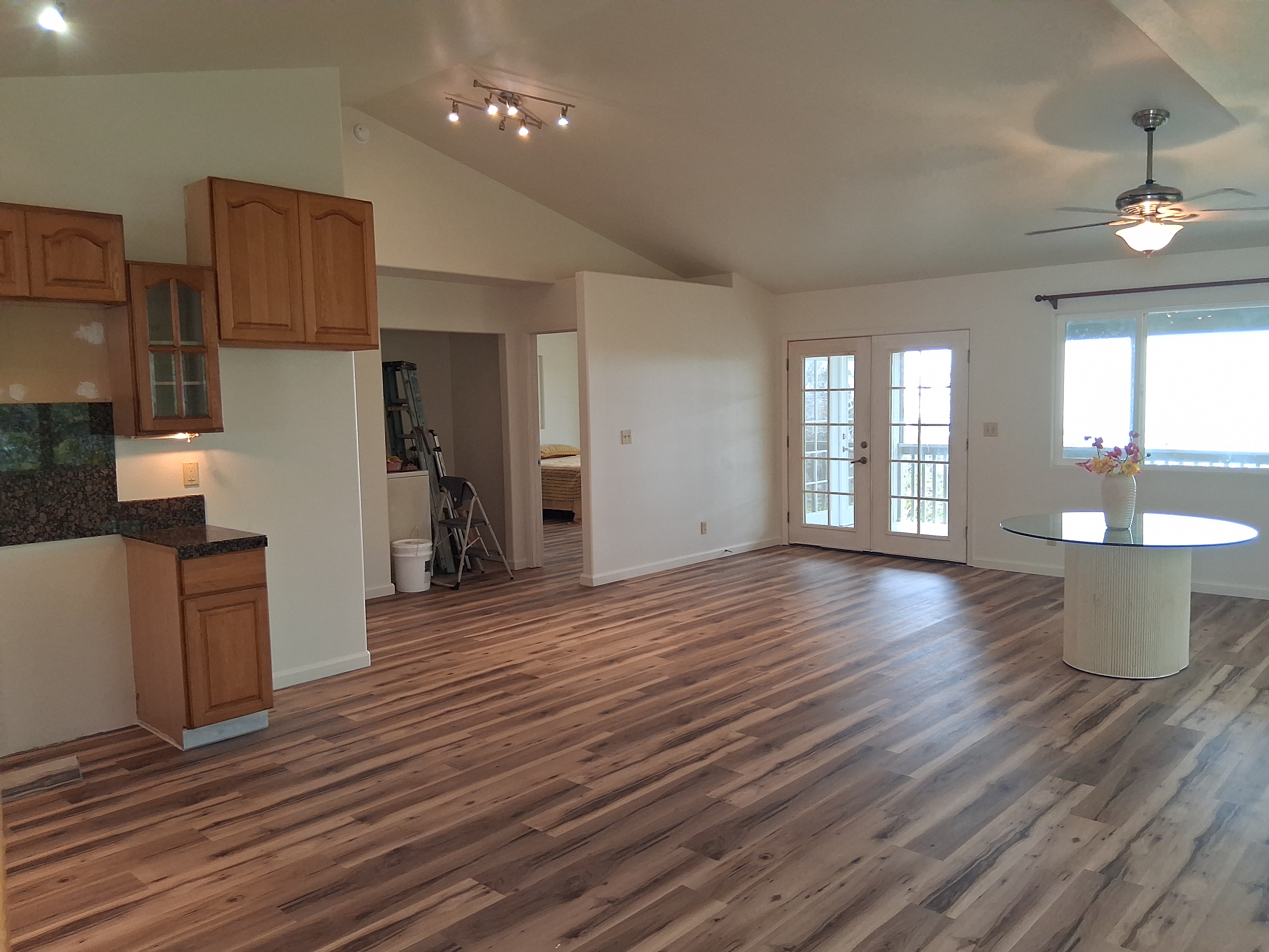 92-8221 Reef Parkway Ocean View, HI 96704 - Photo 6 of 20 an empty room with wooden floor and windows