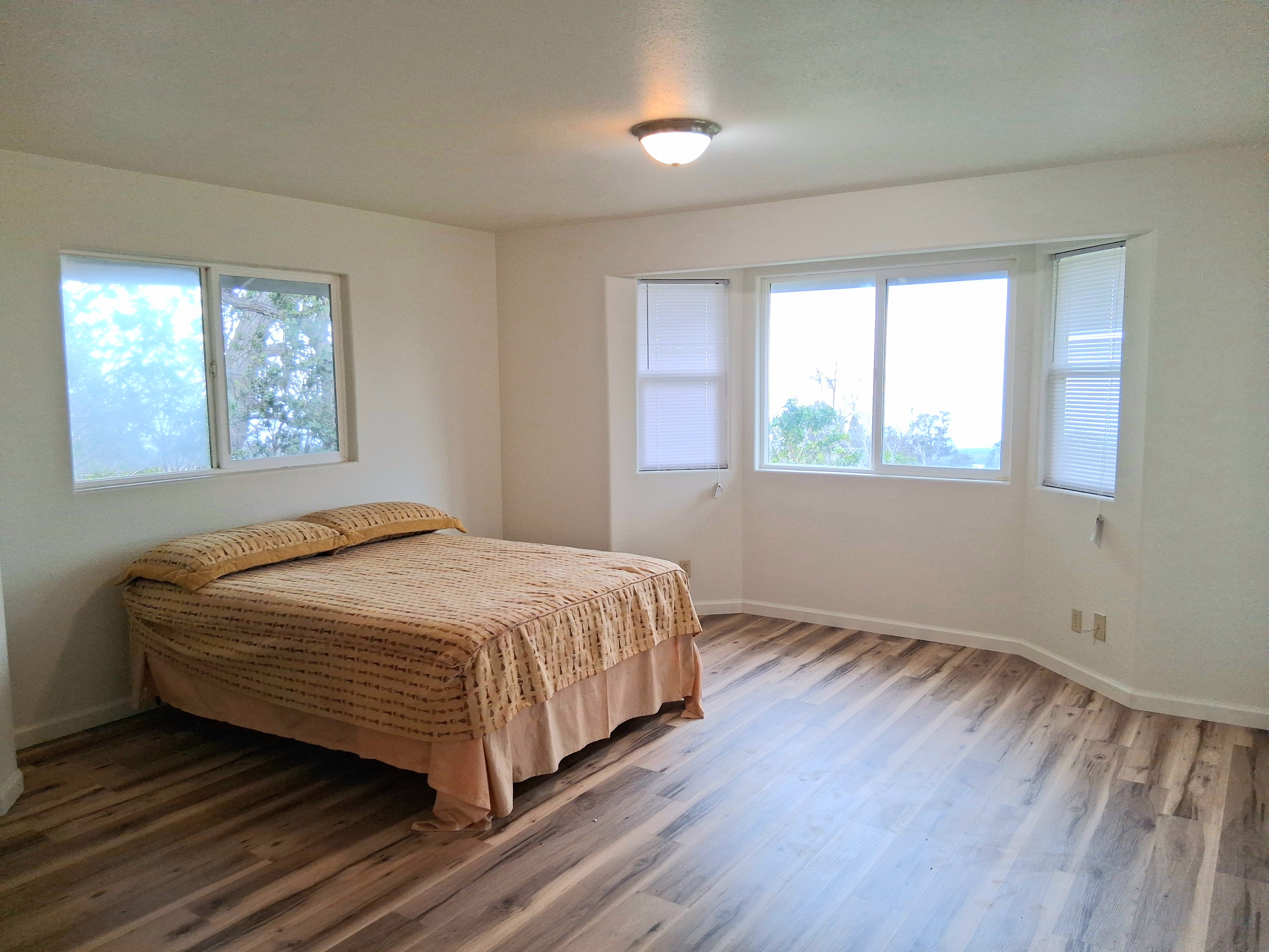 92-8221 Reef Parkway Ocean View, HI 96704 - Photo 9 of 20 a bedroom with a bed and window