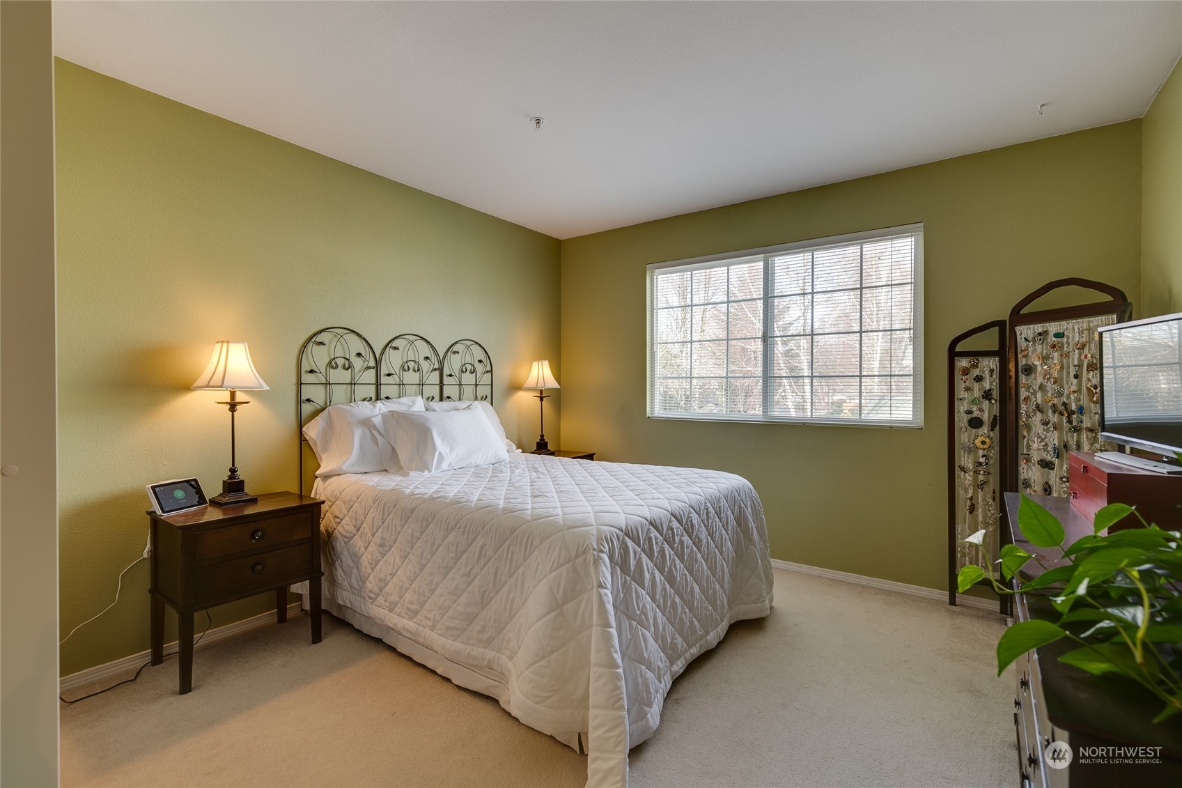 1430 West Casino Road, Unit 213 Everett, WA 98204 - Photo 12 of 31 a bedroom with a bed lamps and a large window