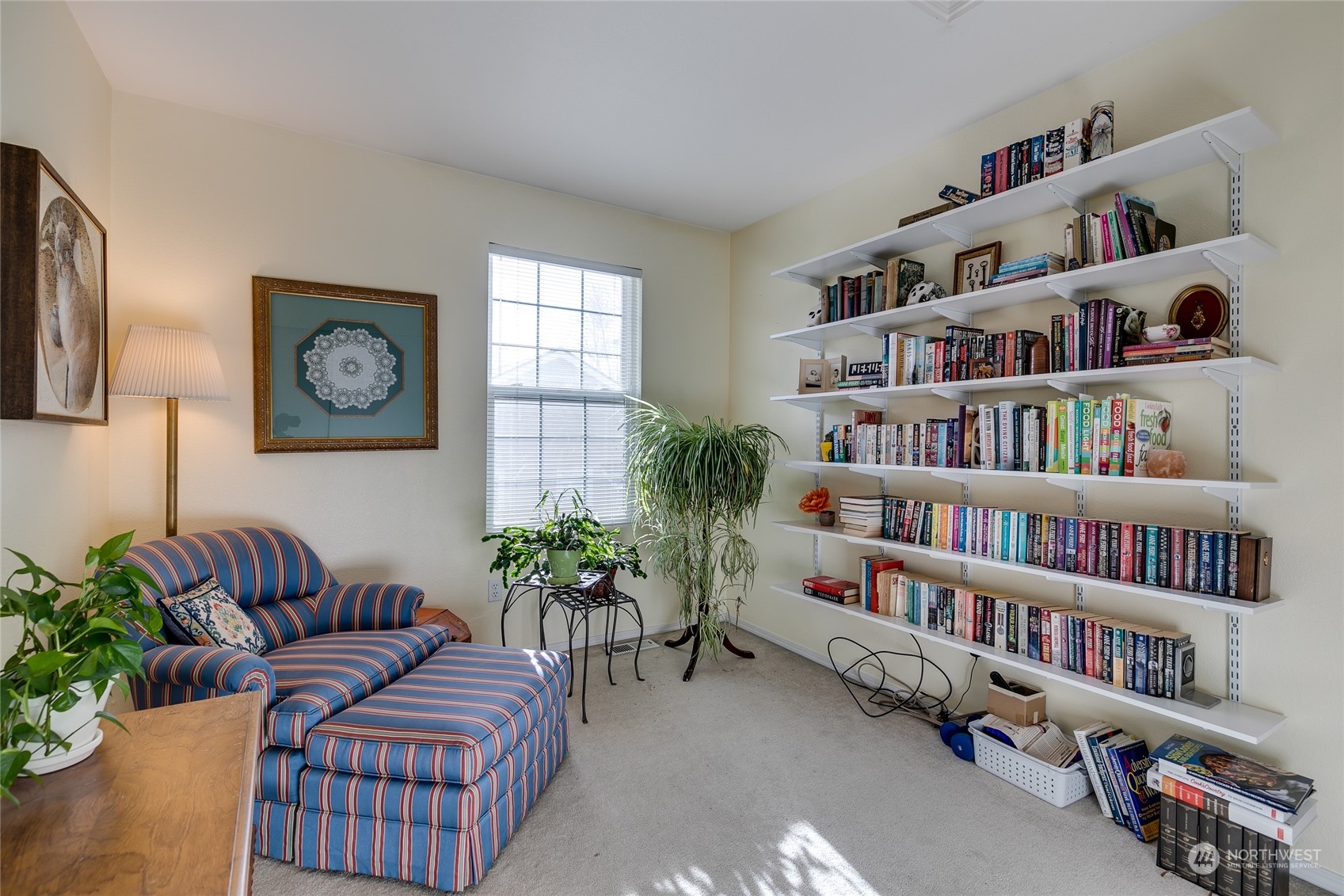 1430 West Casino Road, Unit 213 Everett, WA 98204 - Photo 19 of 31 a living room with furniture and a book shelf