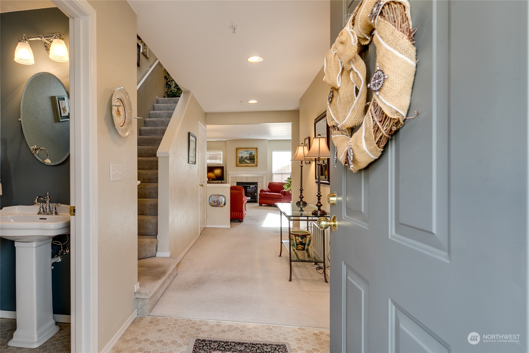 1430 West Casino Road, Unit 213 Everett, WA 98204 - Photo 2 of 31 a hallway with a dining table chairs and entryway