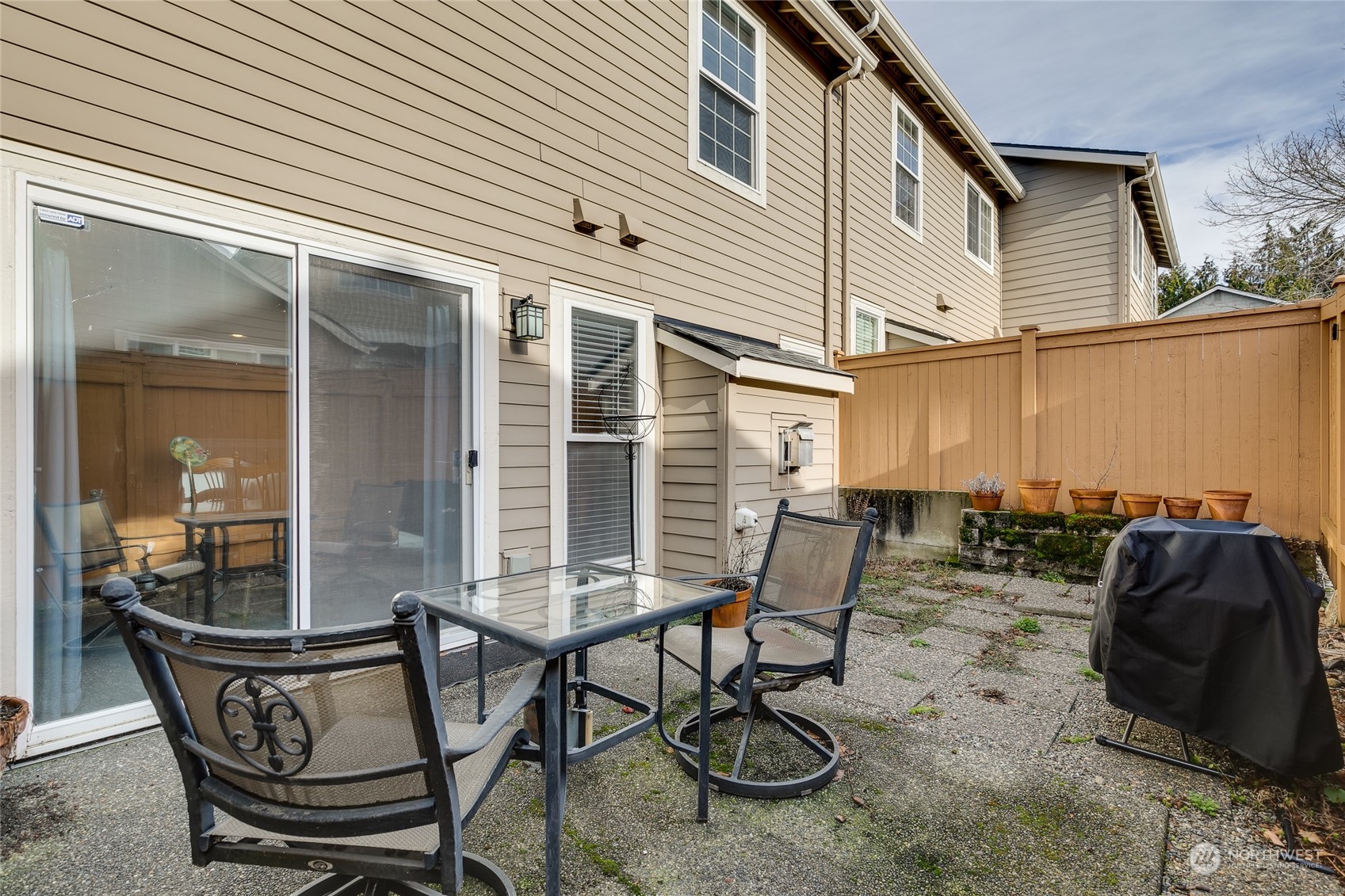 1430 West Casino Road, Unit 213 Everett, WA 98204 - Photo 22 of 31 a view of a patio with table and chairs and potted plants