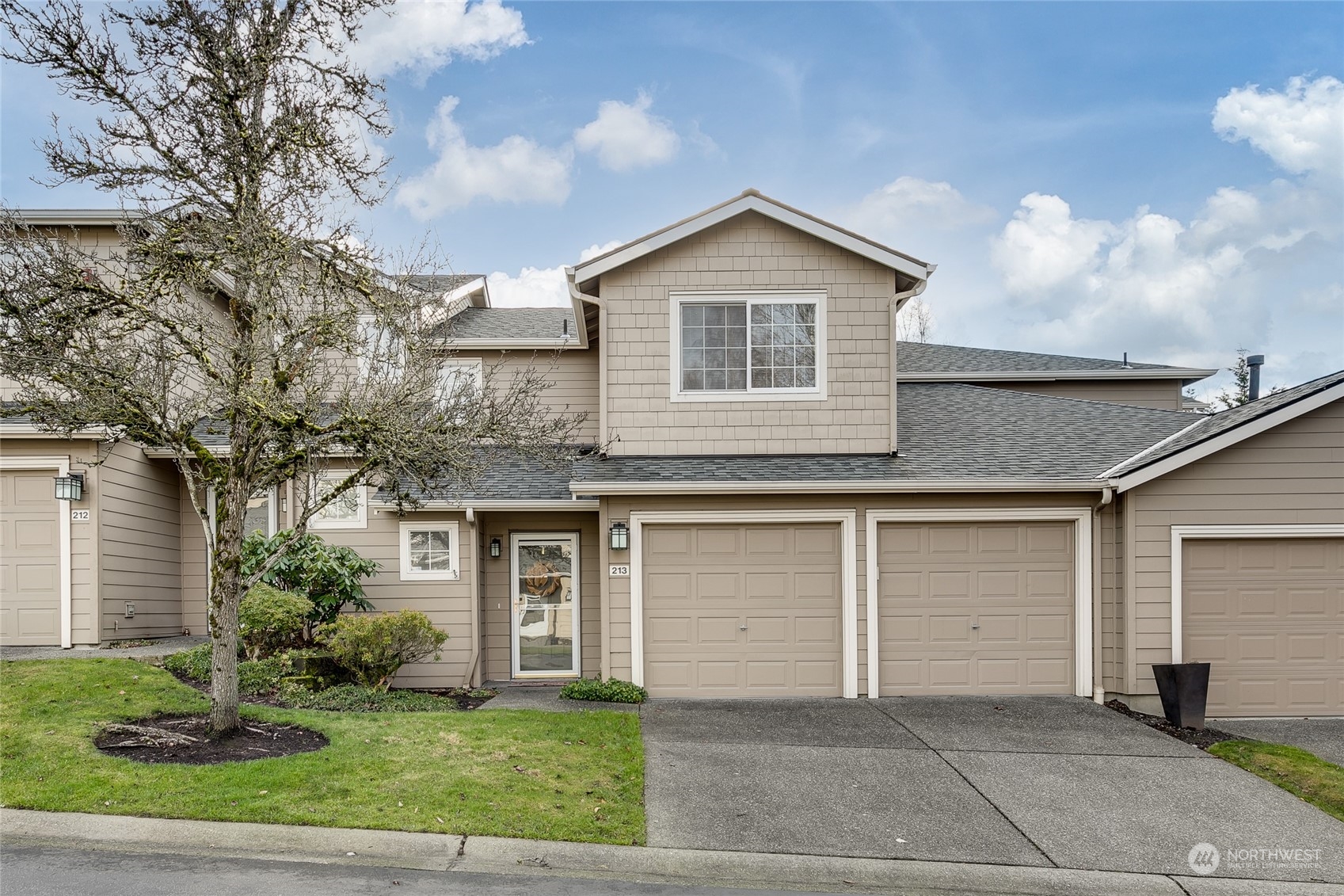 1430 West Casino Road, Unit 213 Everett, WA 98204 - Photo 31 of 31 a front view of a house with a yard and garage