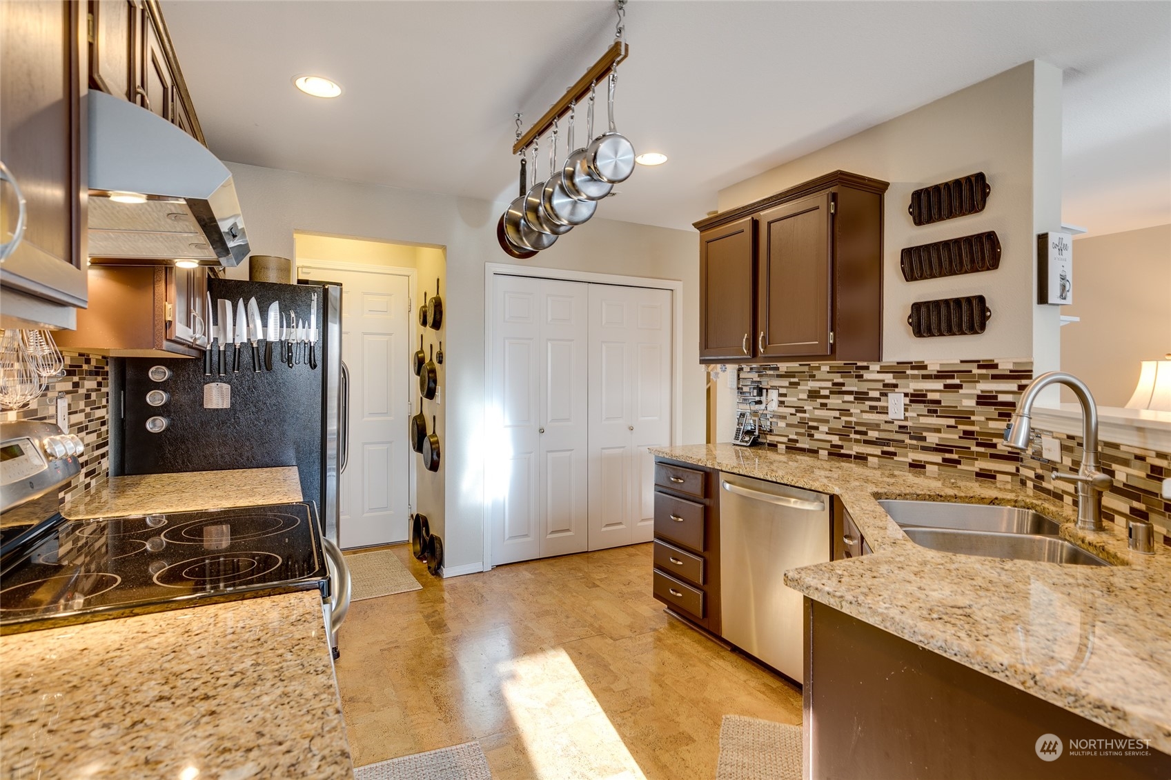 1430 West Casino Road, Unit 213 Everett, WA 98204 - Photo 8 of 31 a kitchen with stainless steel appliances granite countertop a sink and a refrigerator