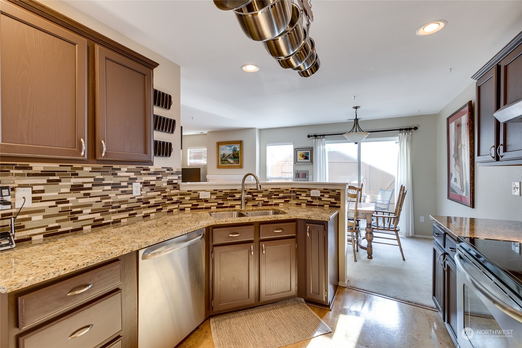 1430 West Casino Road, Unit 213 Everett, WA 98204 - Photo 9 of 31 a kitchen with stainless steel appliances granite countertop a stove and a sink