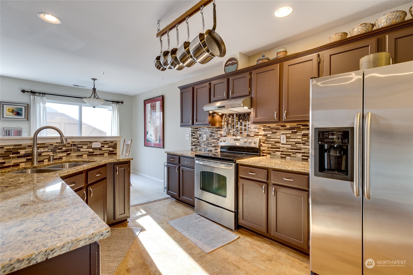 1430 West Casino Road, Unit 213 Everett, WA 98204 - Photo 10 of 31 a kitchen with stainless steel appliances granite countertop a sink a stove and a refrigerator