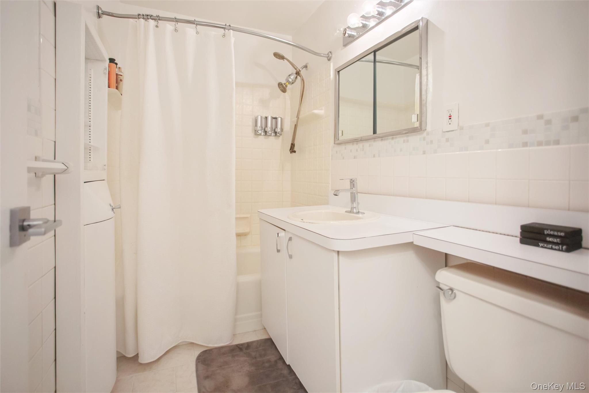 711 Shore Road, Unit 2C Long Beach, NY 11561 - Photo 13 of 27 a bathroom with a sink a toilet and shower