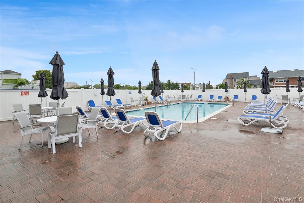 711 Shore Road, Unit 2C Long Beach, NY 11561 - Photo 19 of 27 a view of a swimming pool and lounge chairs