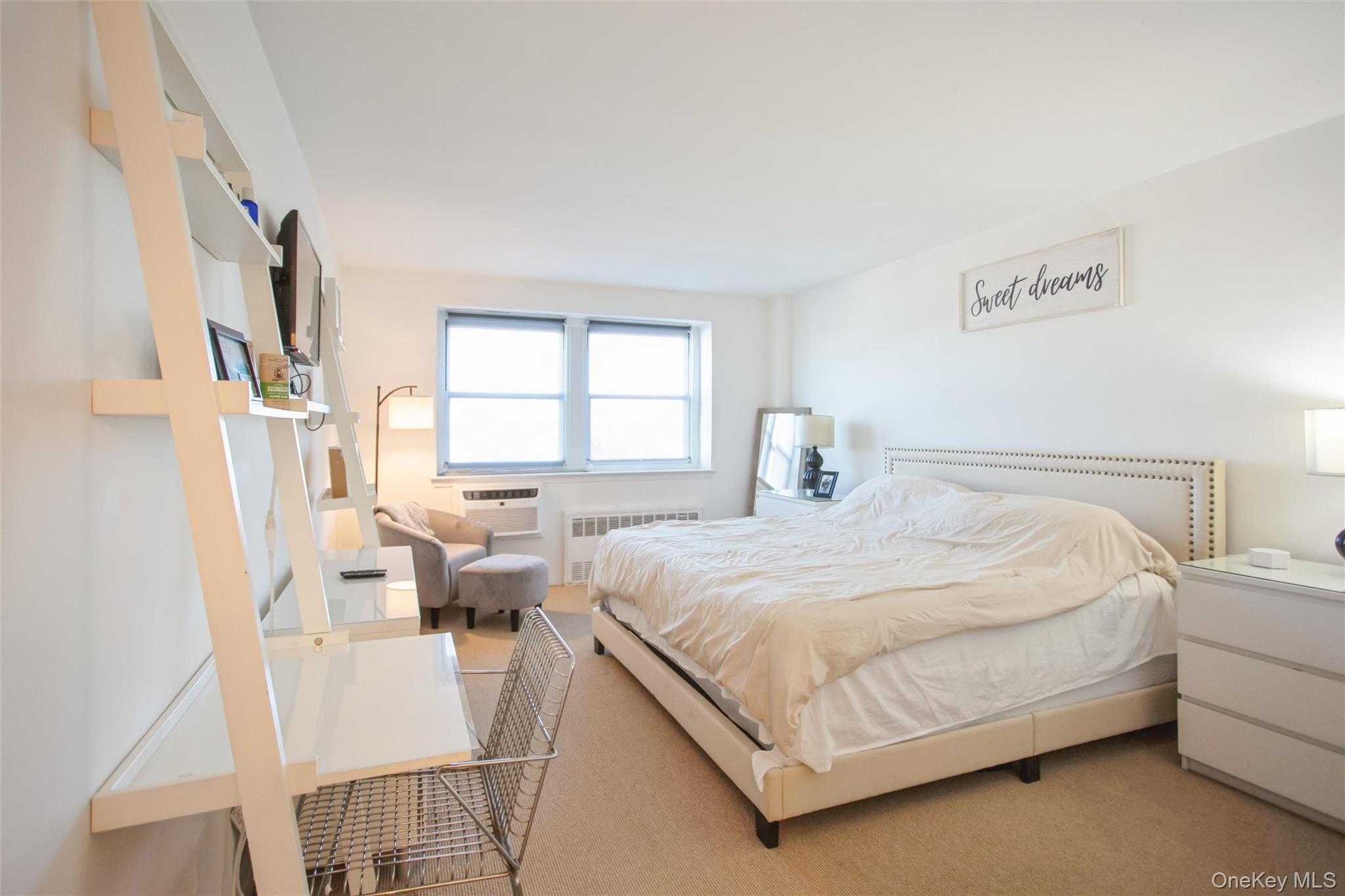 711 Shore Road, Unit 2C Long Beach, NY 11561 - Photo 10 of 27 a bedroom with a bed and a large window