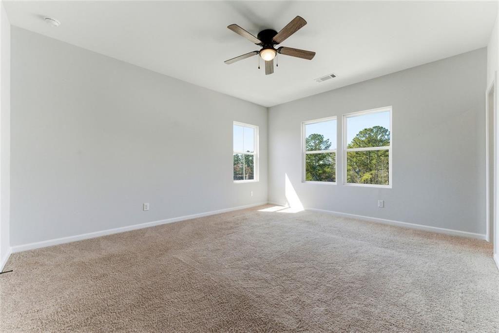1200 Marlo Way Acworth, GA 30102 - Photo 19 of 34 an empty room with a window and a fan