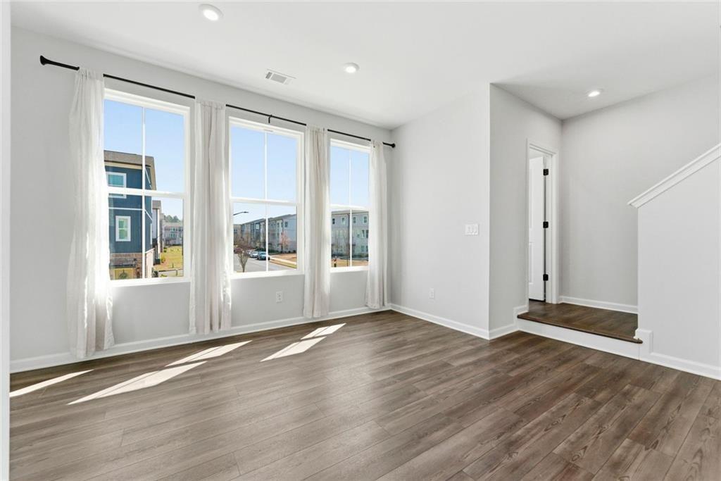 1200 Marlo Way Acworth, GA 30102 - Photo 26 of 34 a view of an empty room with wooden floor and a window