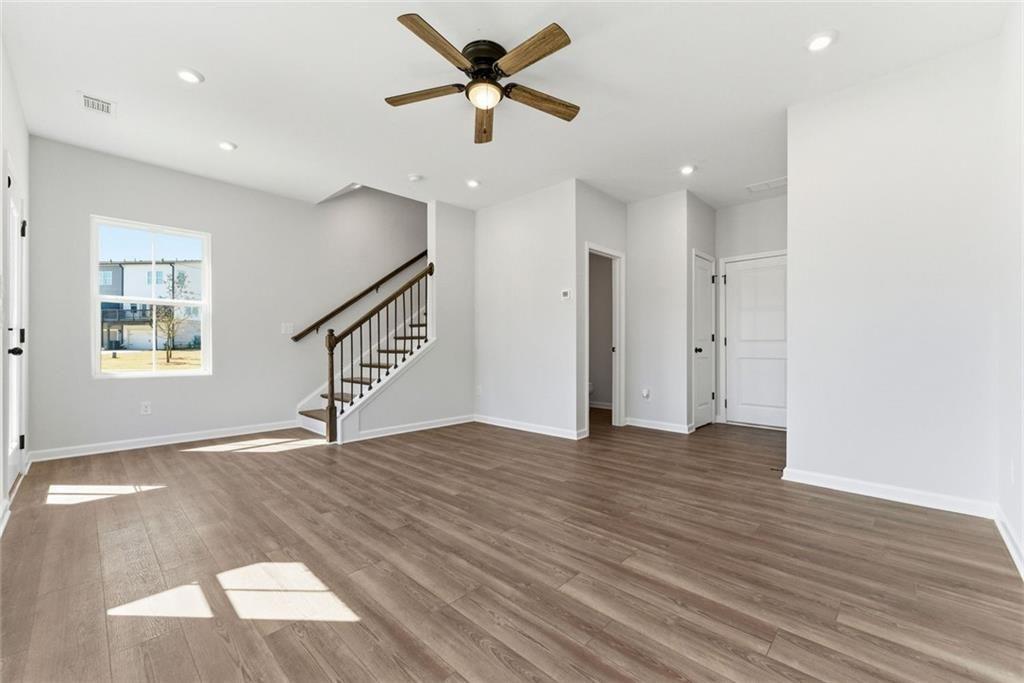 1200 Marlo Way Acworth, GA 30102 - Photo 5 of 34 a view of an empty room with wooden floor and a ceiling fan