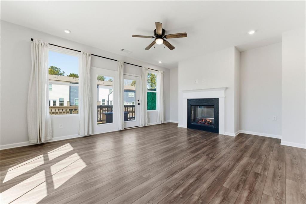 1200 Marlo Way Acworth, GA 30102 - Photo 8 of 34 wooden floor fireplace and windows in an empty room