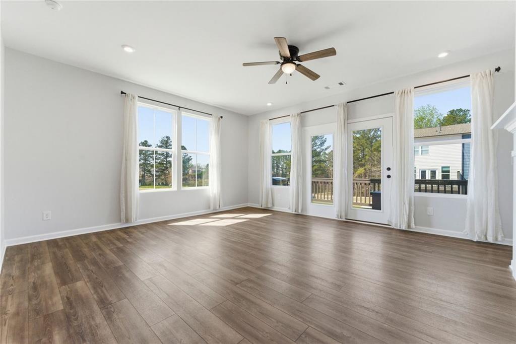 1200 Marlo Way Acworth, GA 30102 - Photo 9 of 34 a view of an empty room with a window and wooden floor