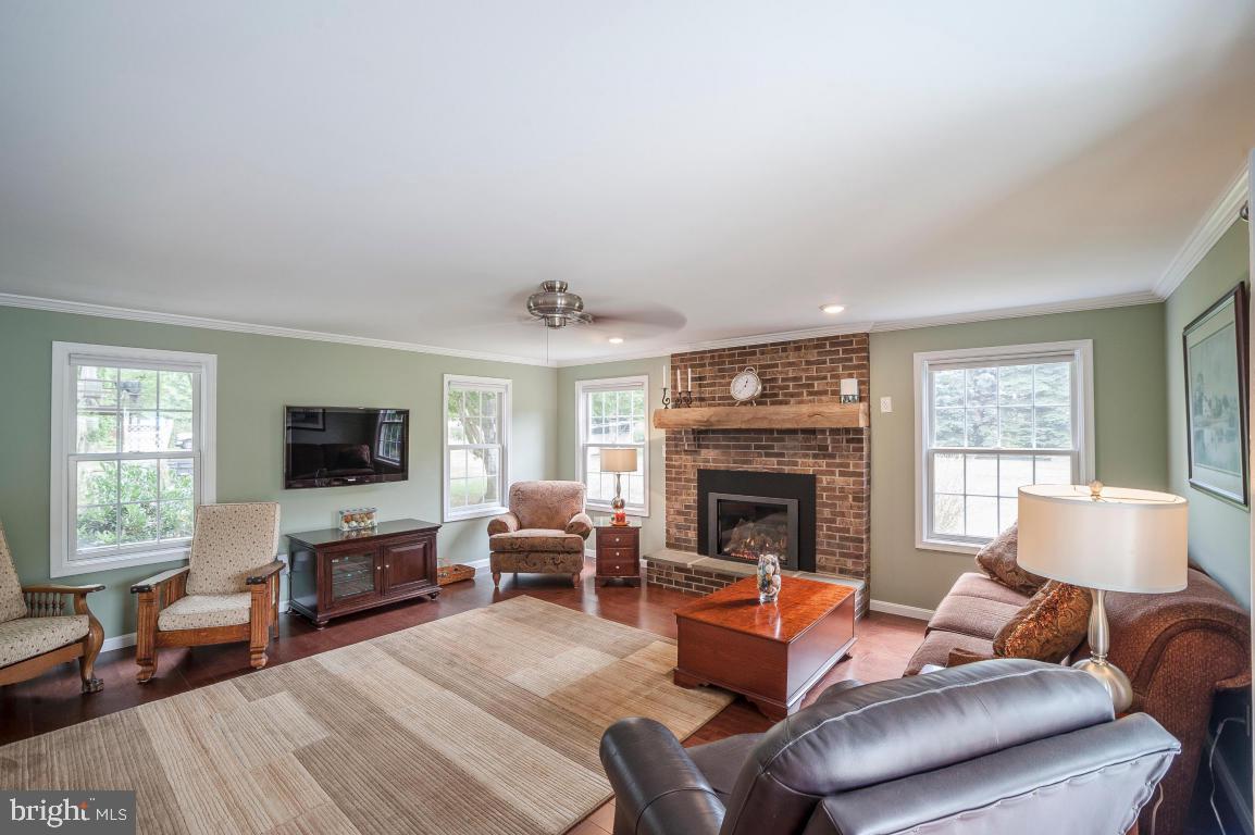 26 Buttonwood Drive Lititz, PA 17543 - Photo 6 of 39 a living room with furniture a fireplace and a flat screen tv