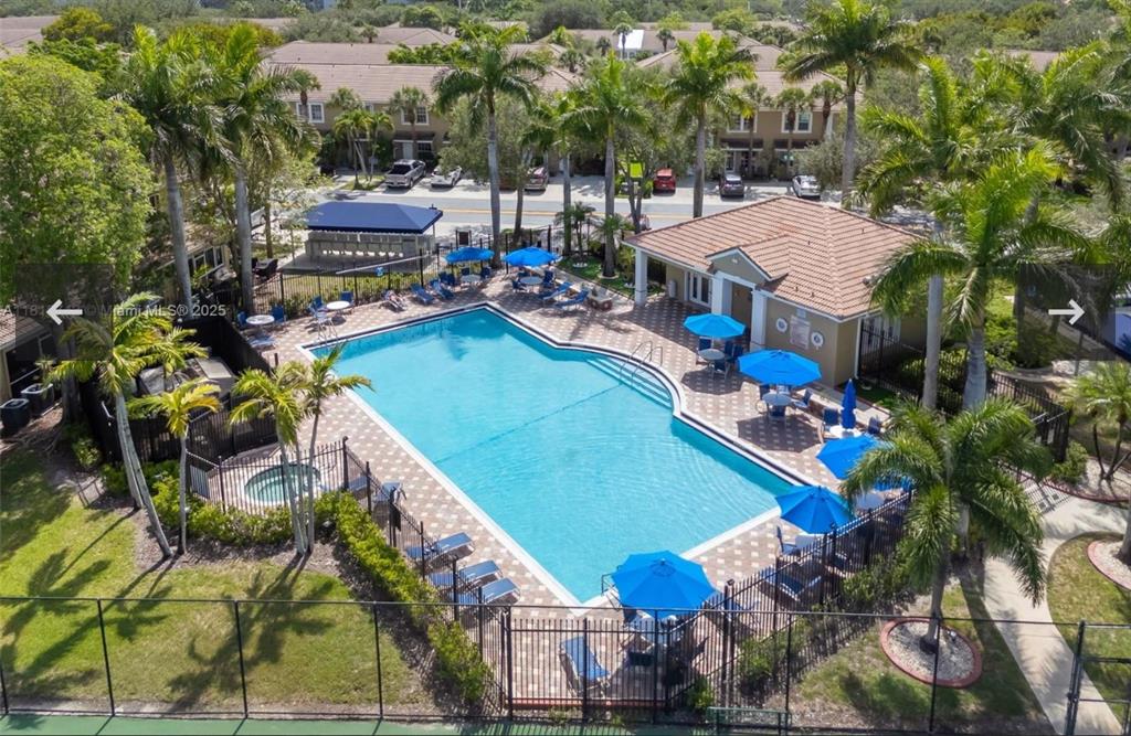 12017 Southwest 2nd Street, Unit 12017 Pembroke Pines, FL 33025 - Photo 11 of 13 a view of a house with a backyard and swimming pool