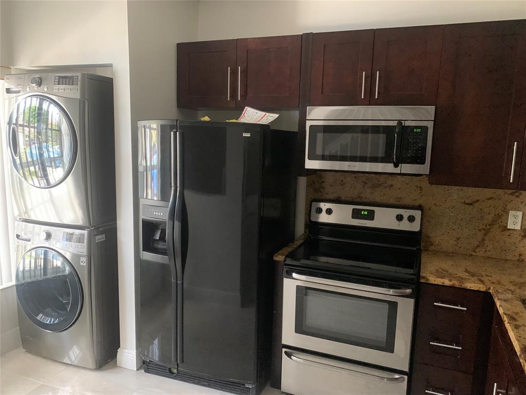 12017 Southwest 2nd Street, Unit 12017 Pembroke Pines, FL 33025 - Photo 3 of 13 a kitchen with a stove and a microwave