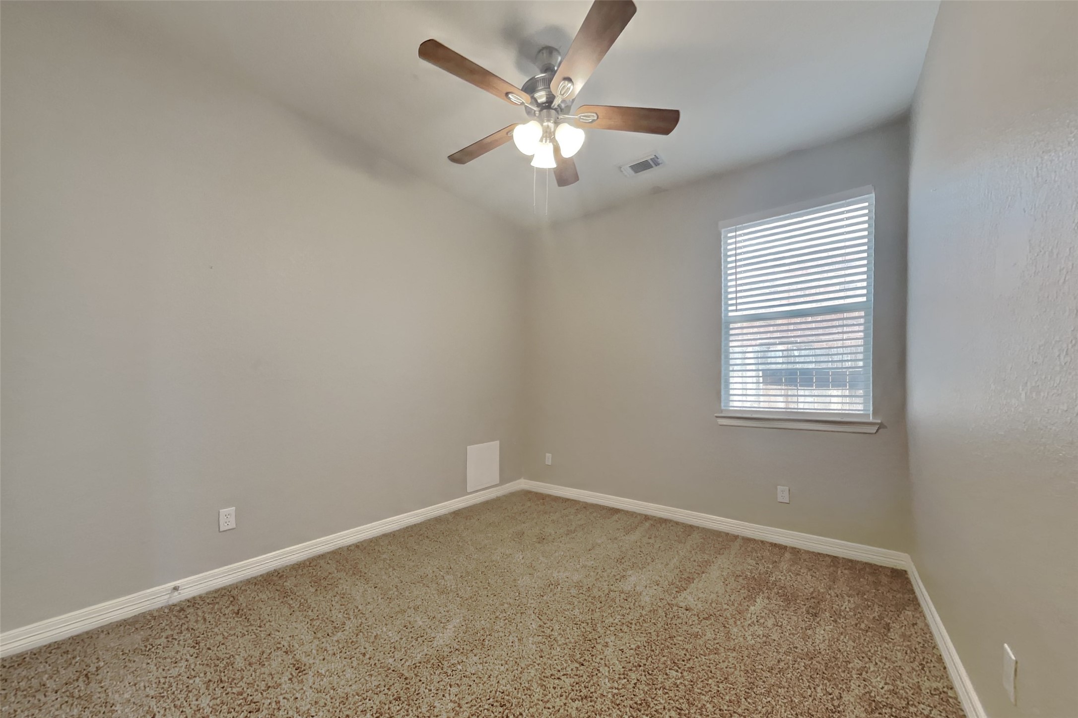 2815 Lockeridge Oaks Drive Spring, TX 77386 - Photo 14 of 18 an empty room with a window and a ceiling fan