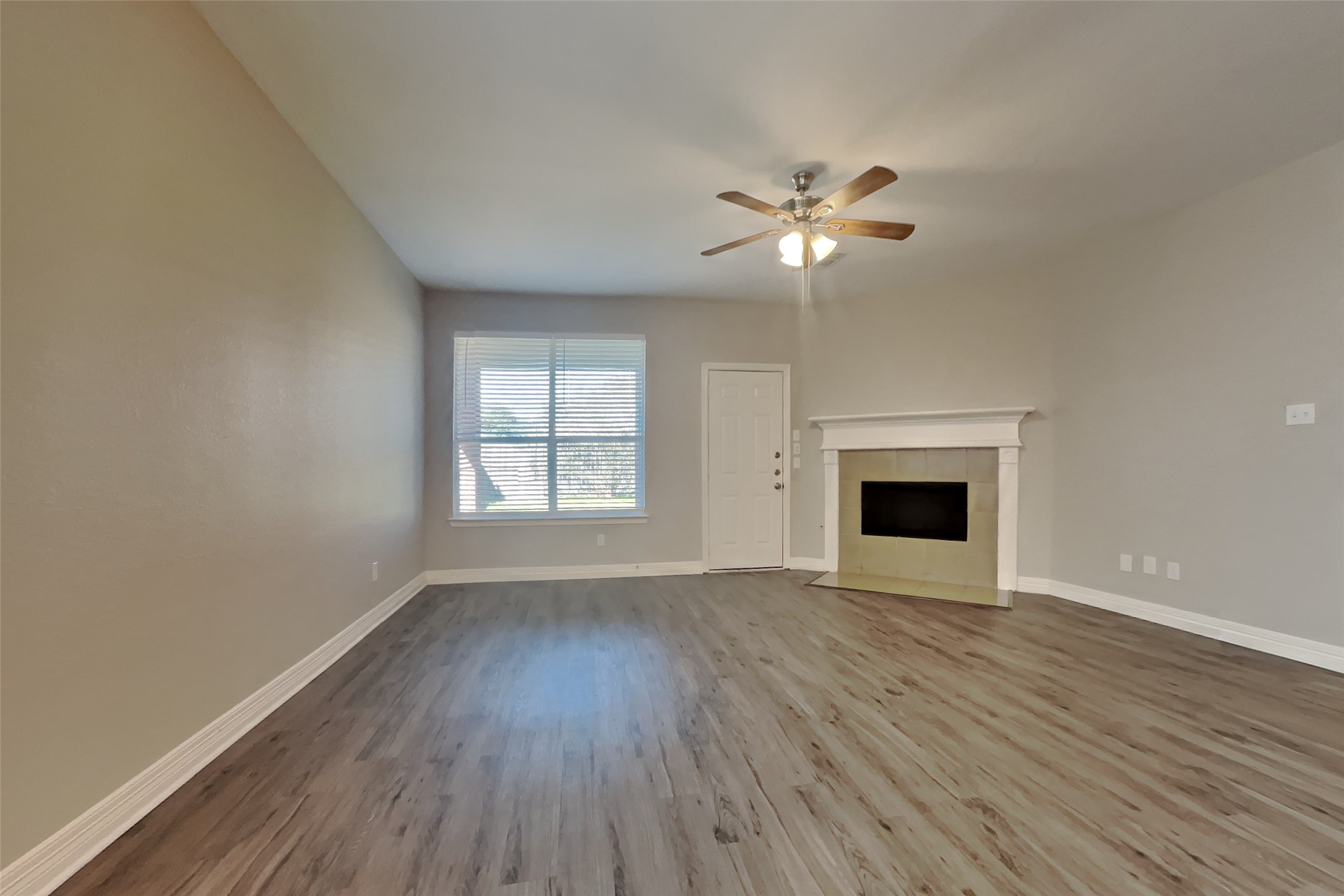 2815 Lockeridge Oaks Drive Spring, TX 77386 - Photo 2 of 18 a view of empty room with wooden floor and fan