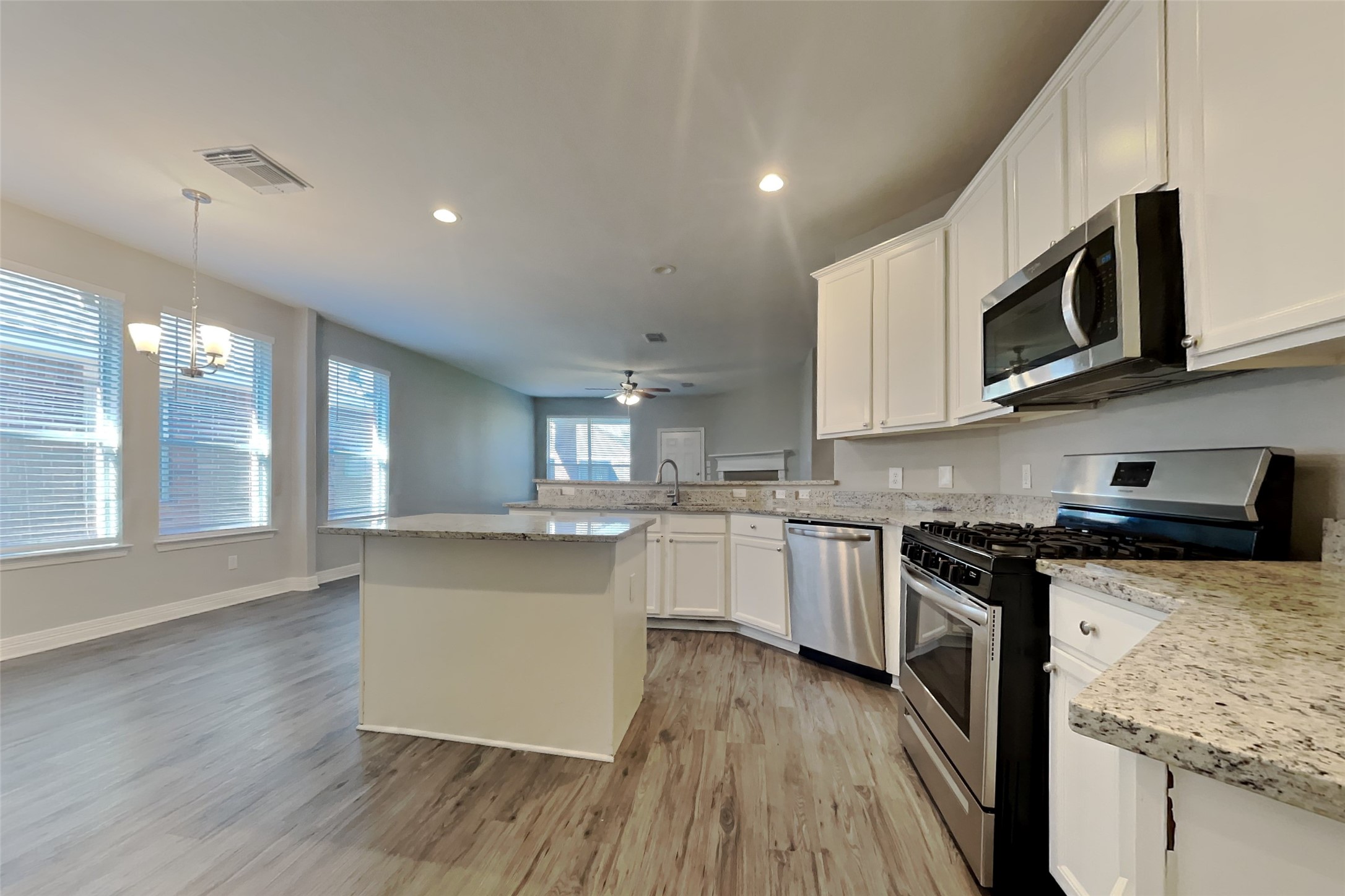 2815 Lockeridge Oaks Drive Spring, TX 77386 - Photo 4 of 18 a kitchen with stainless steel appliances granite countertop wooden cabinets and a stove top oven