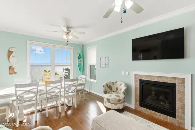 a living room with furniture a flat screen tv and a fireplace