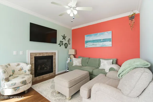 a living room with furniture a flat screen tv and a fireplace