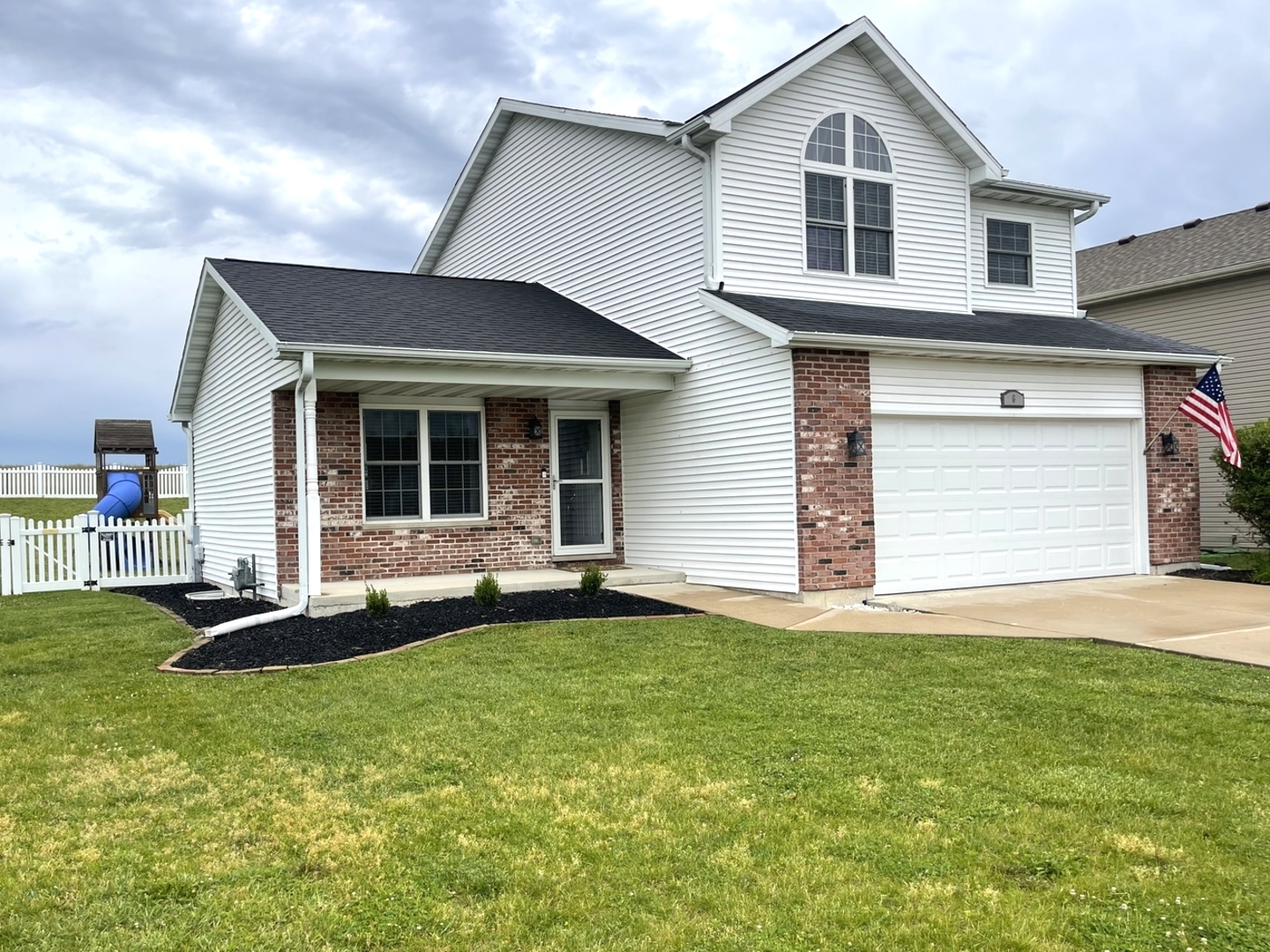 a front view of a house with a yard and garage