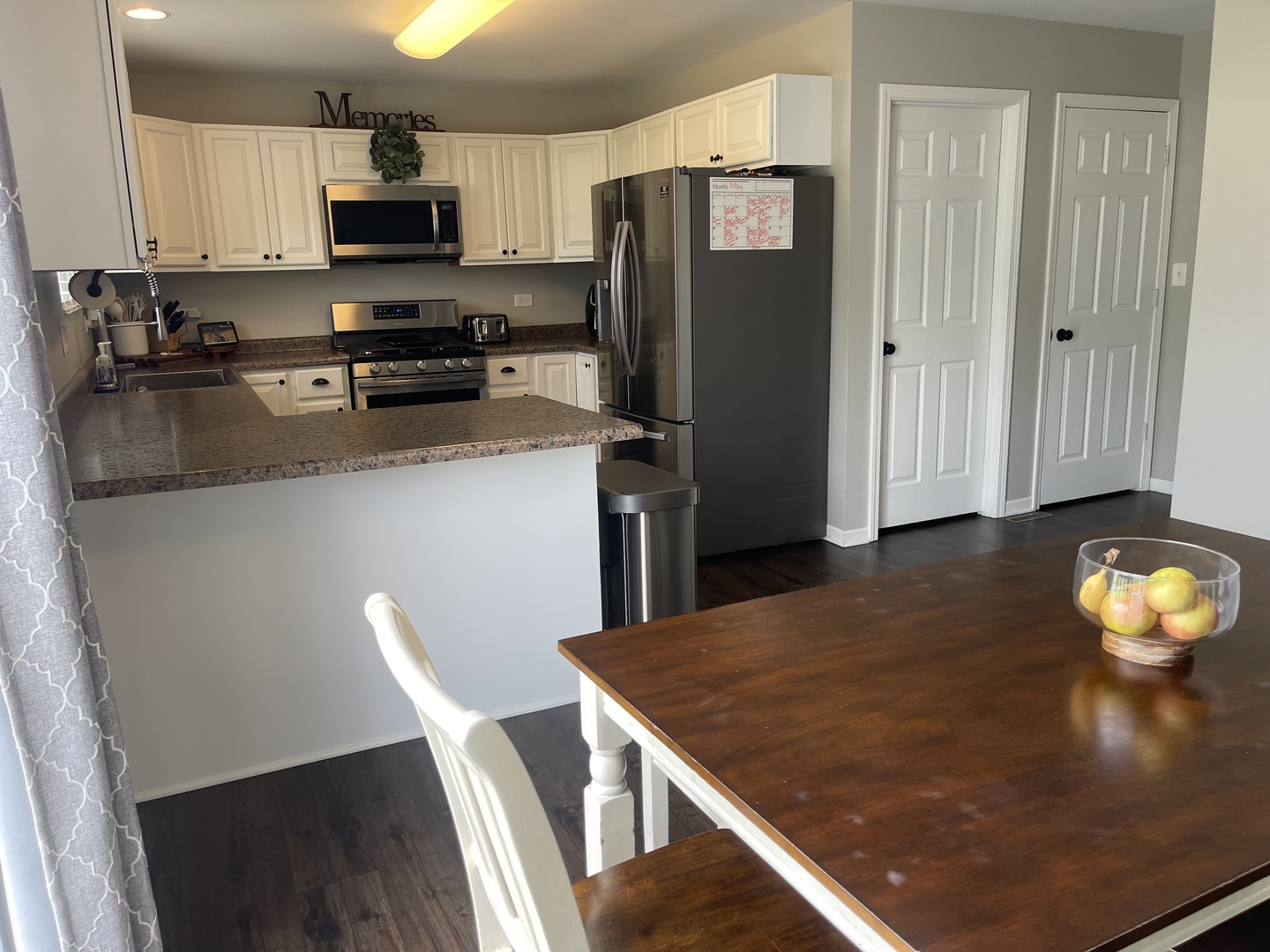 6 Emily Drive Spring Valley, IL 61362 - Photo 7 of 25 a kitchen with stainless steel appliances granite countertop a refrigerator a stove a sink dishwasher and white cabinets with wooden floor