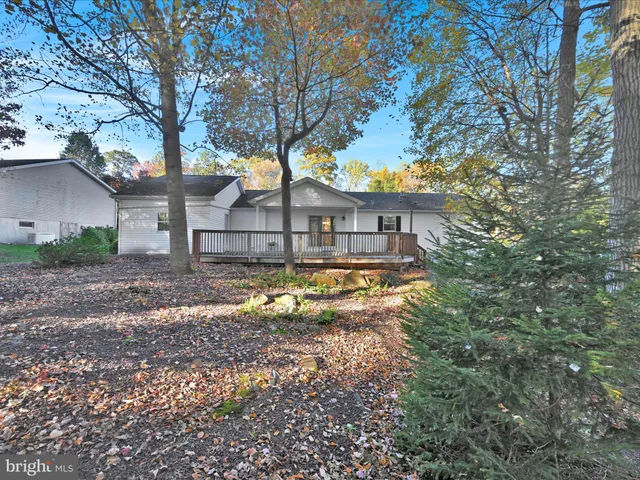 a view of house with yard and swimming pool