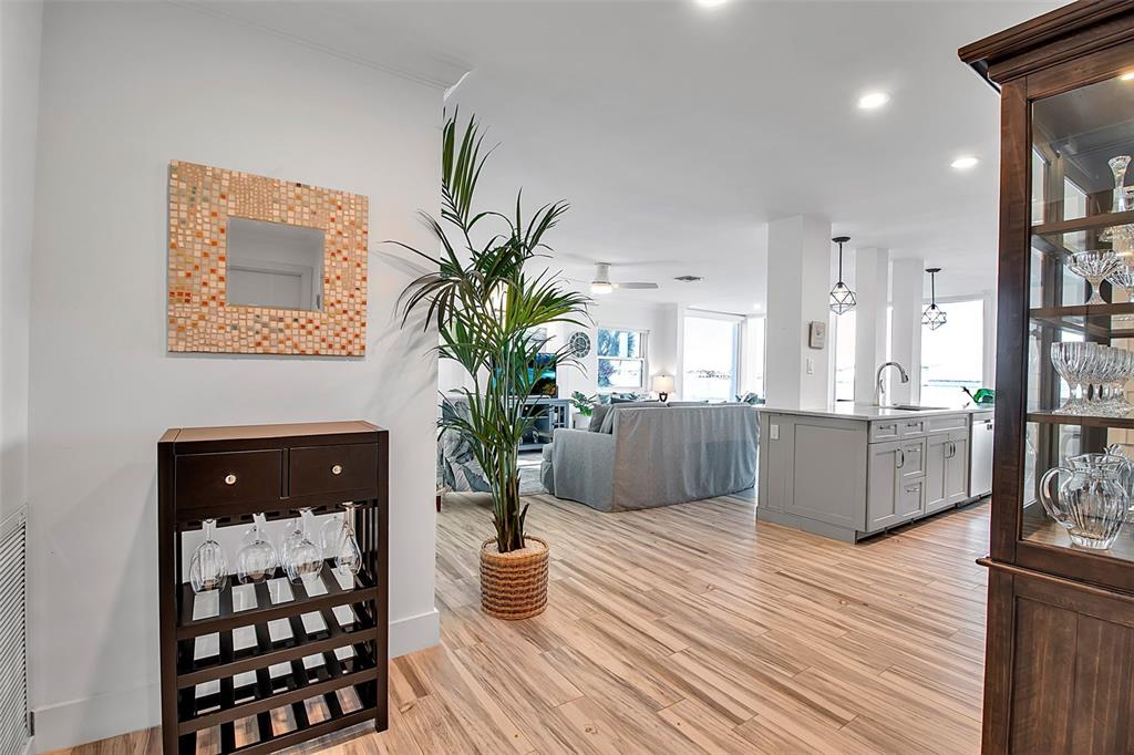 226 Golden Gate Point, Unit 21 Sarasota, FL 34236 - Photo 12 of 55 a living room with furniture a potted plant and kitchen view