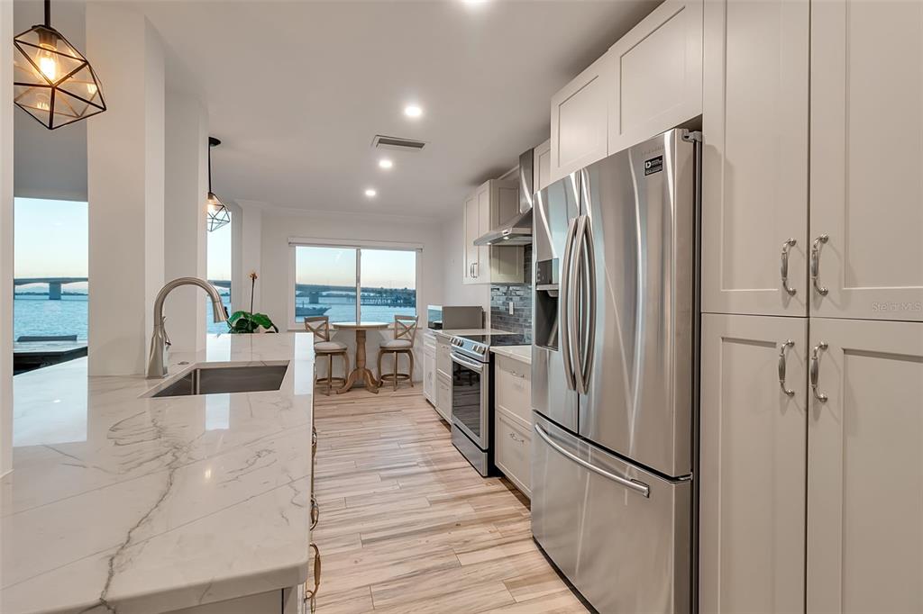 226 Golden Gate Point, Unit 21 Sarasota, FL 34236 - Photo 14 of 55 a kitchen with stainless steel appliances a refrigerator and a stove top oven