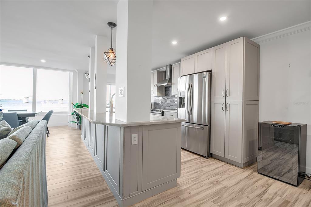 226 Golden Gate Point, Unit 21 Sarasota, FL 34236 - Photo 15 of 55 a kitchen with stainless steel appliances a refrigerator a stove a sink cabinets and wooden floor