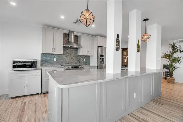 a kitchen with stainless steel appliances granite countertop a sink and stove