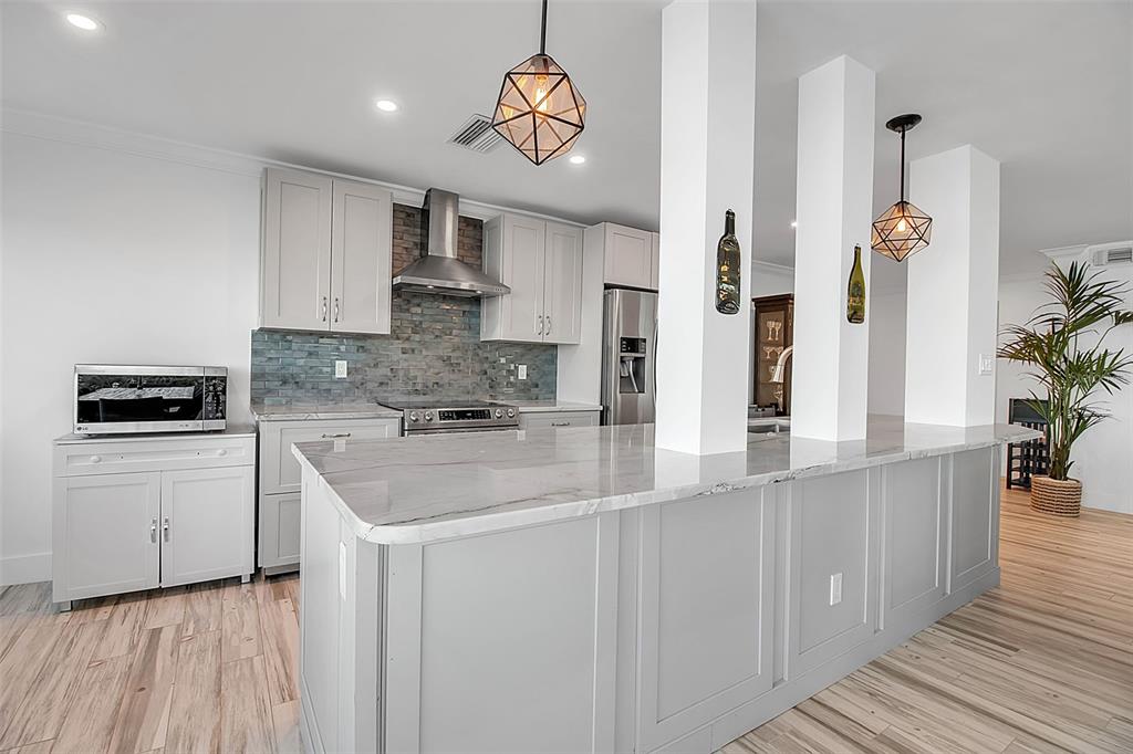 226 Golden Gate Point, Unit 21 Sarasota, FL 34236 - Photo 17 of 55 a kitchen with stainless steel appliances granite countertop a sink a stove and cabinets