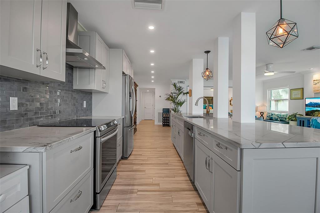 226 Golden Gate Point, Unit 21 Sarasota, FL 34236 - Photo 19 of 55 a kitchen with stainless steel appliances granite countertop a sink and stove