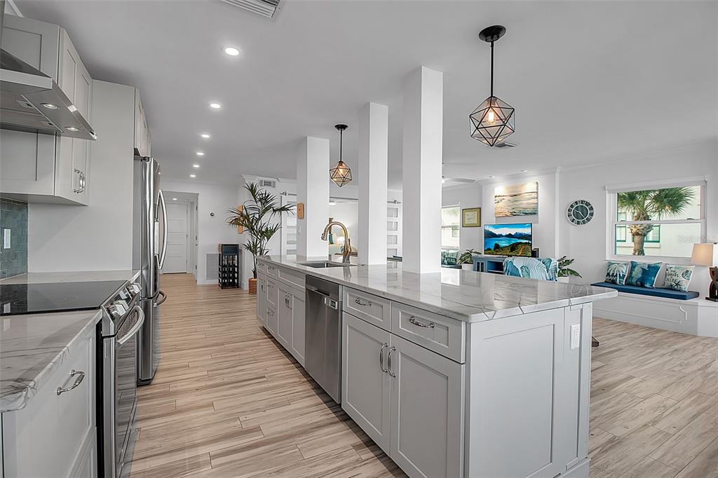 226 Golden Gate Point, Unit 21 Sarasota, FL 34236 - Photo 20 of 55 a kitchen with stainless steel appliances kitchen island granite countertop a stove a sink and a wooden floors