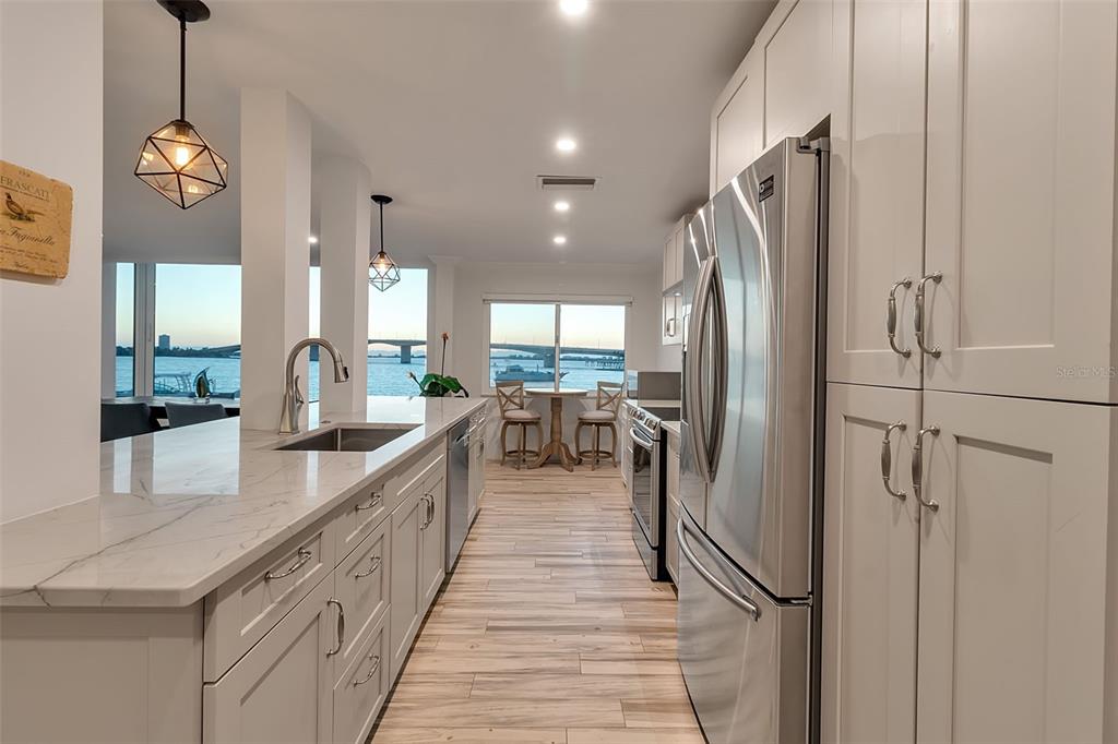 226 Golden Gate Point, Unit 21 Sarasota, FL 34236 - Photo 23 of 55 a kitchen with stainless steel appliances granite countertop a refrigerator a oven and a sink