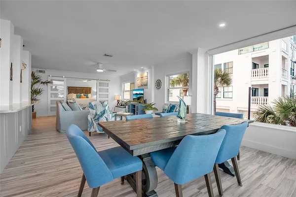 a view of a dining room with furniture and wooden floor