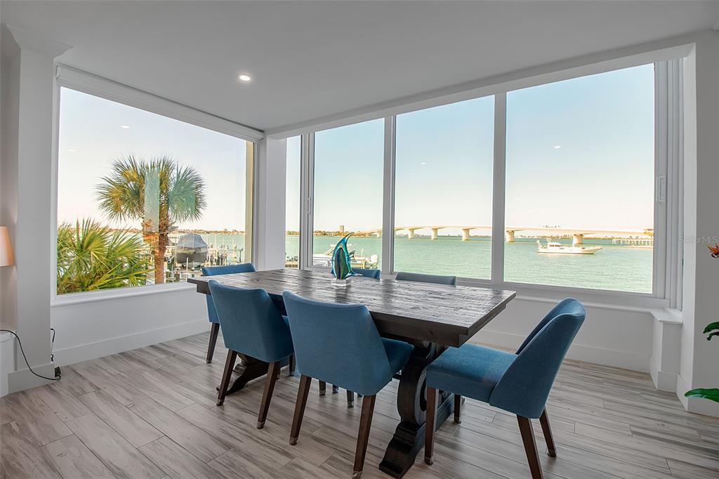 226 Golden Gate Point, Unit 21 Sarasota, FL 34236 - Photo 27 of 55 a dining room with furniture and wooden floor