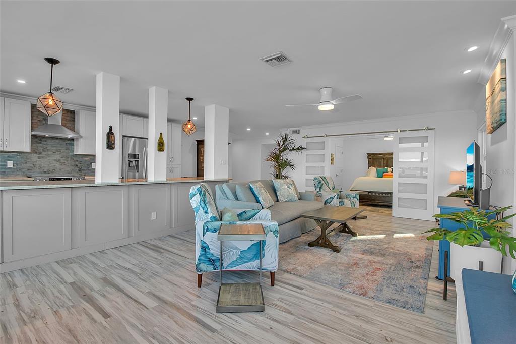 226 Golden Gate Point, Unit 21 Sarasota, FL 34236 - Photo 29 of 55 a living room with furniture and a wooden floor
