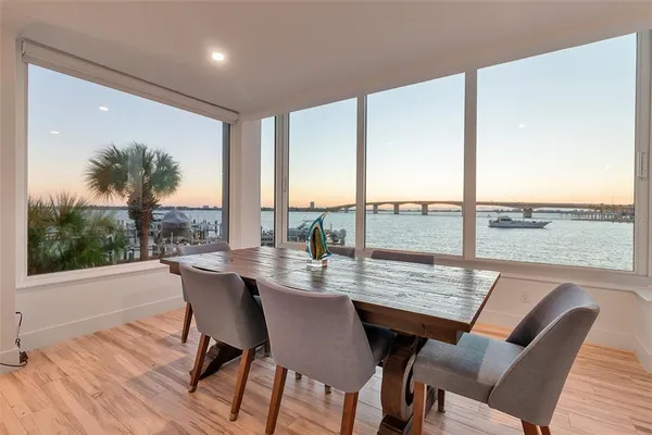 a dining room with furniture window and wooden floor