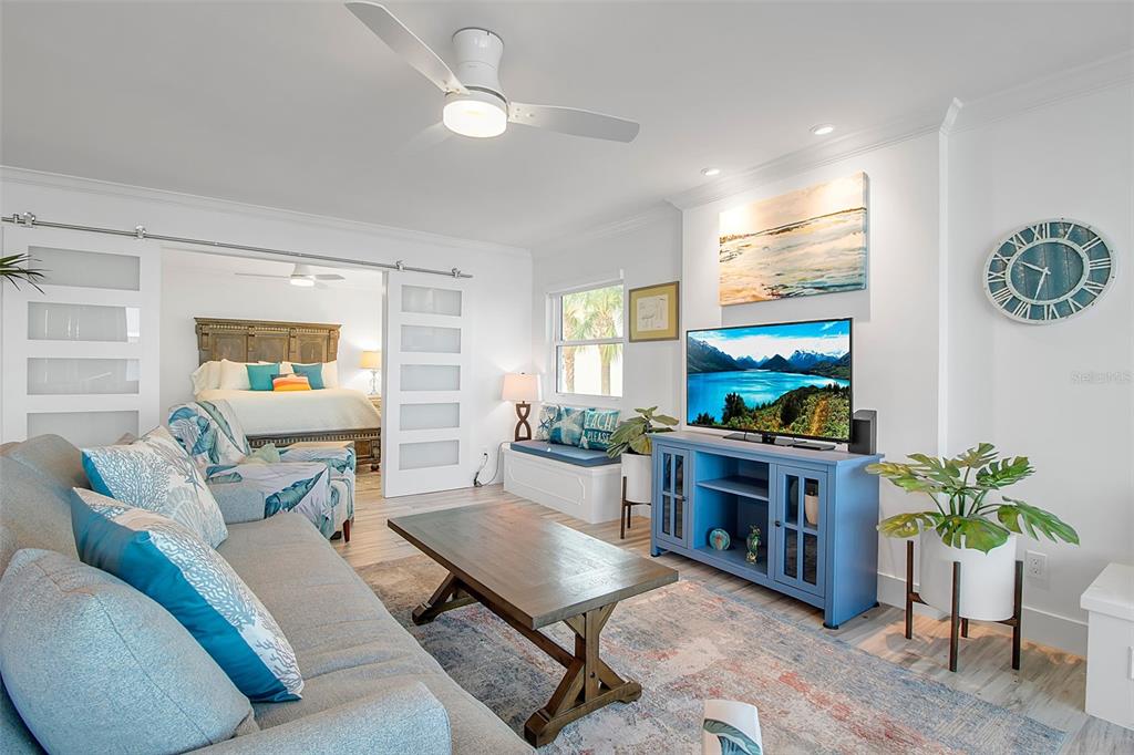 226 Golden Gate Point, Unit 21 Sarasota, FL 34236 - Photo 31 of 55 a living room with furniture and a flat screen tv