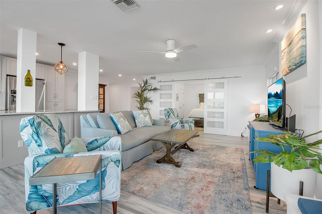 226 Golden Gate Point, Unit 21 Sarasota, FL 34236 - Photo 33 of 55 a living room with furniture and a potted plant