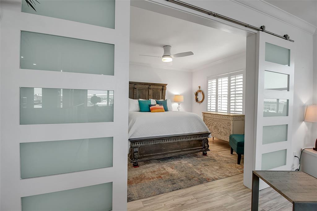 226 Golden Gate Point, Unit 21 Sarasota, FL 34236 - Photo 37 of 55 a living room with a bed furniture and a window