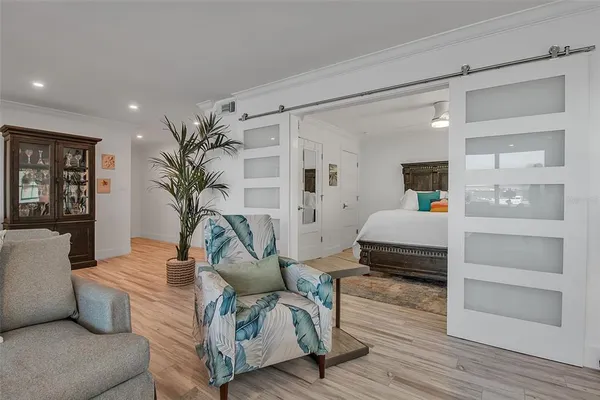 a bedroom with bed and a large window