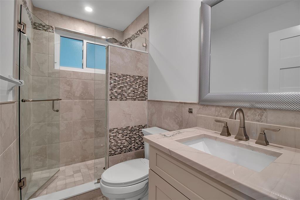 226 Golden Gate Point, Unit 21 Sarasota, FL 34236 - Photo 39 of 55 a bathroom with a sink a toilet and shower